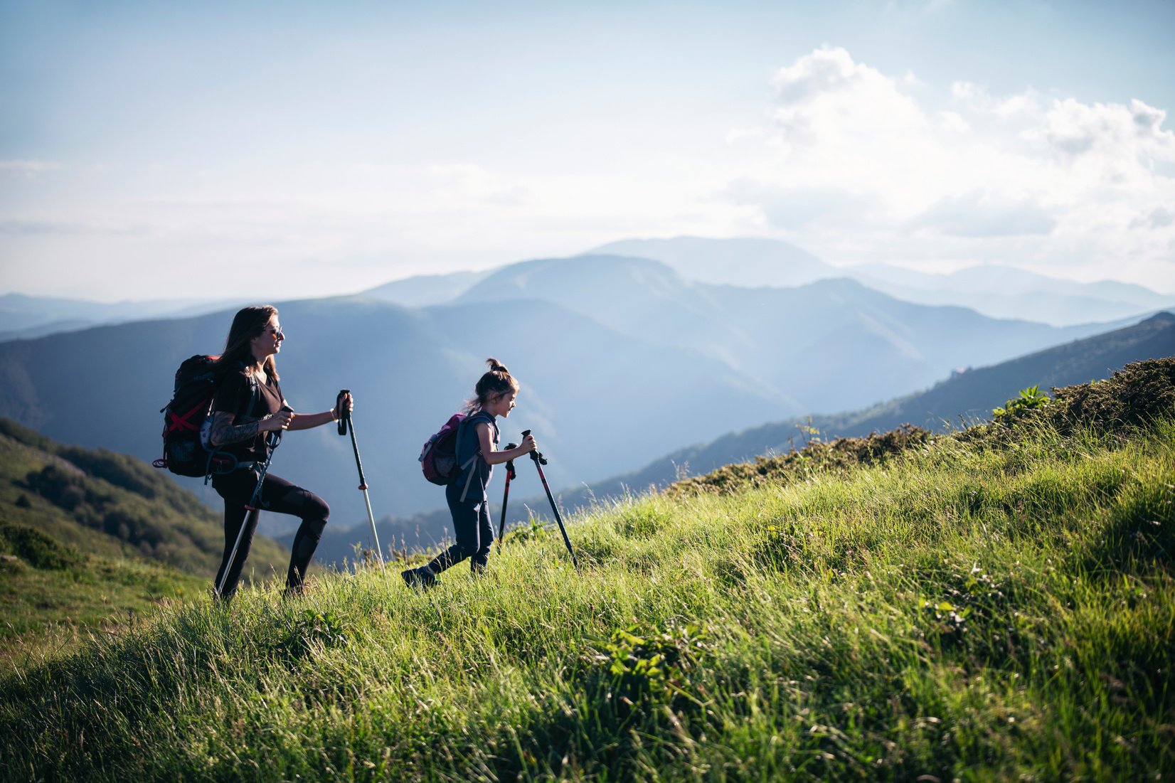 Family Hiking In Mountains.